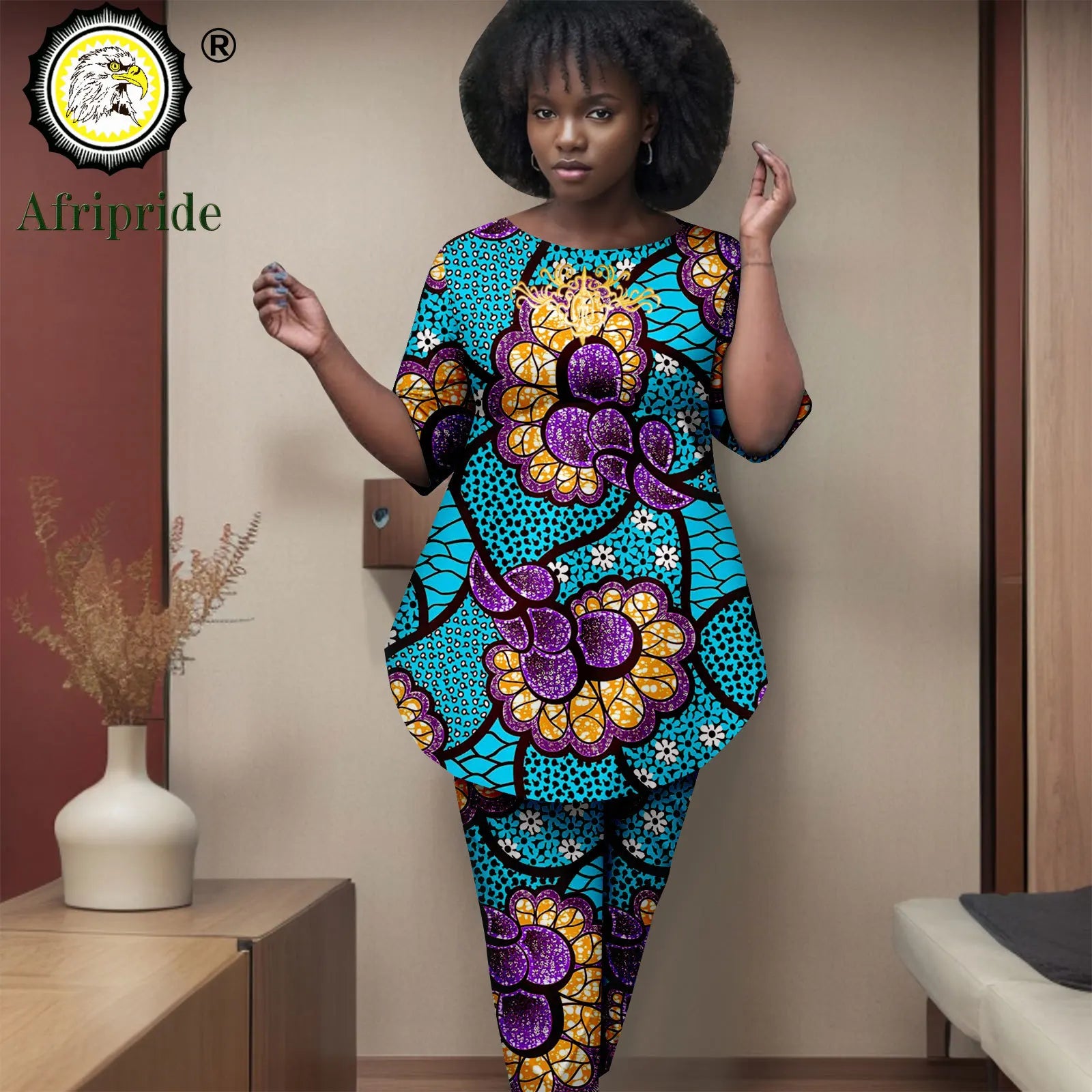 Woman wearing a colorful floral outfit with 'Afripride' branding in the corner.