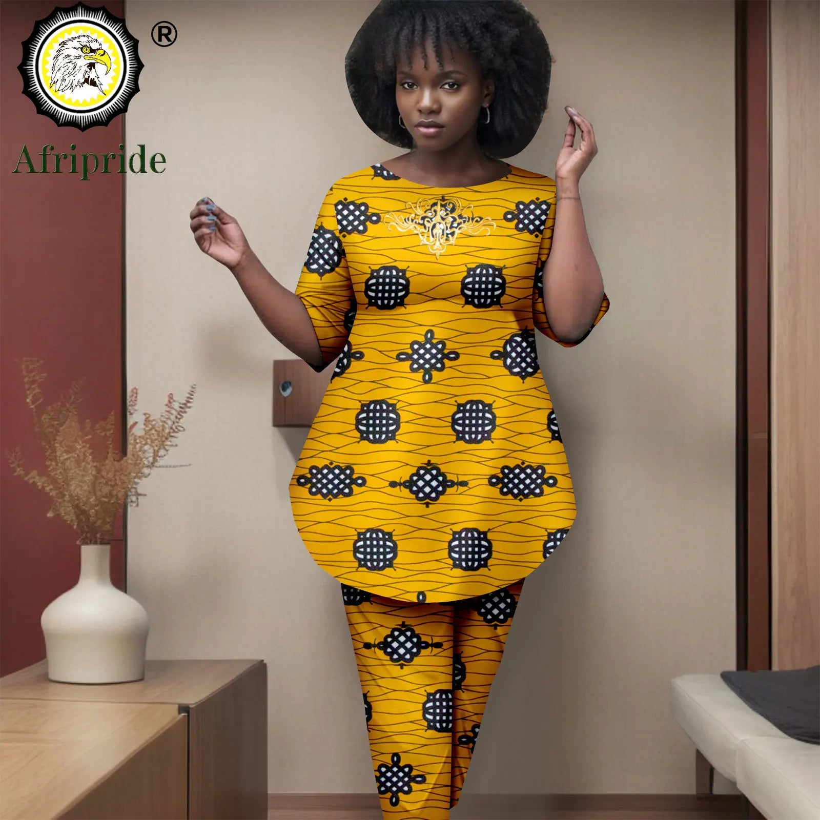 Woman wearing a yellow and black patterned outfit with 'Afripride' branding.